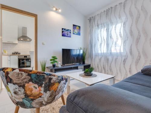 a living room with a couch and a table at Apartment Tramonto-2 by Interhome in Vir