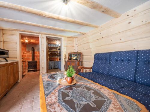 a living room with a blue couch and a table at Holiday Home Relax & Play by Interhome in Čabar