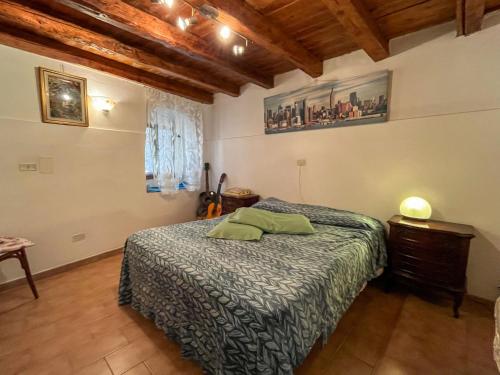 a bedroom with a bed and a wooden ceiling at Apartment Casa Iose by Interhome in Torrazza