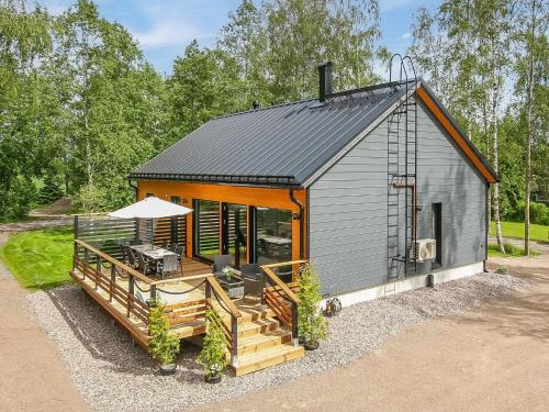 a small house with a porch and a deck at Holiday Home Lukupirtti by Interhome in Säkylä