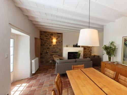 a living room with a table and a couch at Holiday Home La Dolce Vita Brezhoneg by Interhome in Trémeven