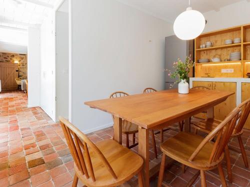 a dining room with a wooden table and chairs at Holiday Home La Dolce Vita Brezhoneg by Interhome in Trémeven