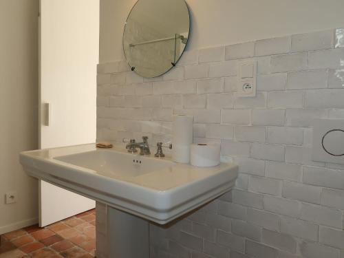 a white bathroom sink with a mirror on the wall at Holiday Home La Dolce Vita Brezhoneg by Interhome in Trémeven
