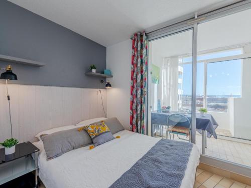 une chambre avec un lit et une grande fenêtre dans l'établissement Studio Porte de la Mer Claudéa by Interhome, au Barcarès