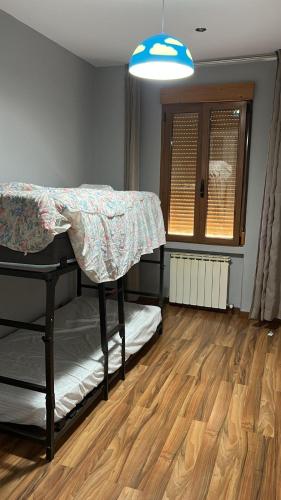 a room with a bed and a wooden floor at Apartamento en Panaderos in Valladolid