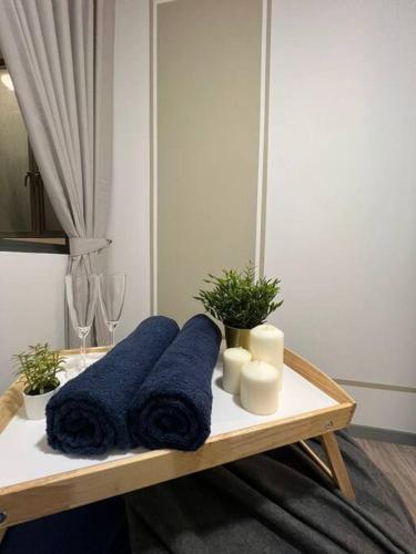 a table with blue towels and candles on it at Idyllic Cottage 3BR Desa Park City Mont Kiara in Kuala Lumpur