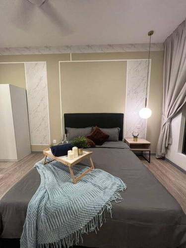 a bedroom with a large bed with a table on it at Idyllic Cottage 3BR Desa Park City Mont Kiara in Kuala Lumpur