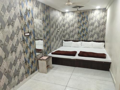 a bedroom with a bed and a wall at Star villa hotel in Ujjain