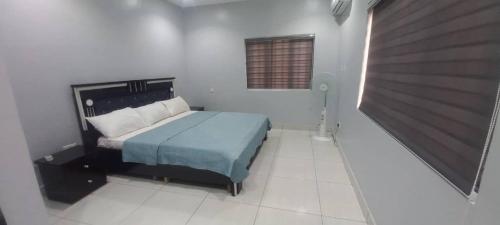 a bedroom with a bed in a white room at Lekki shared apartment in Lekki