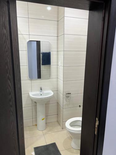 a bathroom with a sink and a toilet at Lekki shared apartment in Lekki