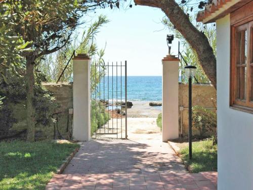 a gate leading to the beach from a house at Holiday Home Fanusa by Interhome in Siracusa