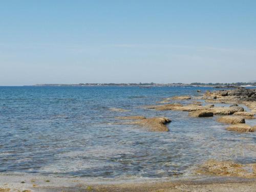 a large body of water with rocks in it at Holiday Home Fanusa by Interhome in Siracusa