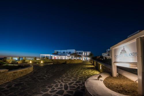a night view of a street with buildings in the background at Cycladic Islands Hotel & Spa in Agia Anna Naxos