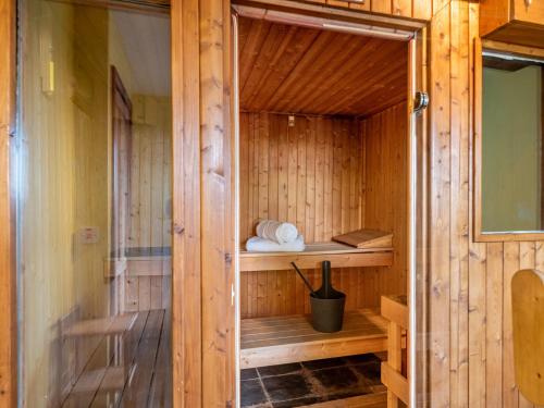 a wooden sauna with a shelf and towels in it at 5 Bed in Garth BN162 in Garth