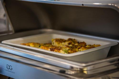 a dish of food in a microwave oven at Cycladic Islands Hotel & Spa in Agia Anna Naxos