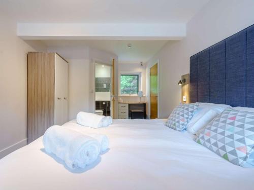 a bedroom with a large white bed and a desk at 2 Bed in Ullswater 80556 in Watermillock