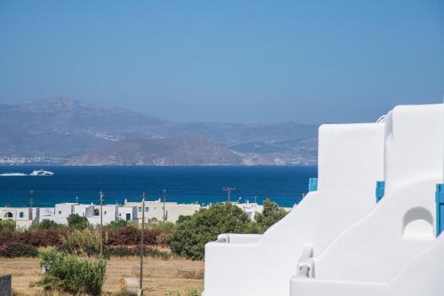a view of the ocean from a white building at Cycladic Islands Hotel & Spa in Agia Anna Naxos