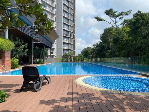 a chair sitting in front of a swimming pool at IOI City Mall Modern Home PICC in Putrajaya