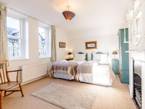 a bedroom with two beds and a fireplace at 2 Bed in Alnmouth 81280 in Alnmouth