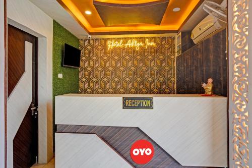 a hotel lobby with a sign on the wall at Super OYO Flagship 81158 Hotel Aditya Inn in Patna