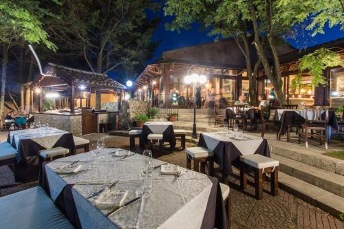 a restaurant with tables and chairs at night at Antica Stazione in Chiaramonte Gulfi