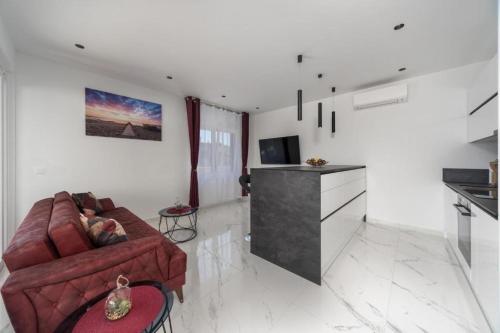 a living room with a couch and a television at Royal House 2 in Pašman
