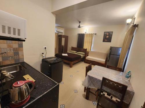 a room with a kitchen and a living room at Coastal Suites Apartment Hotel ---- 8 minutes walk to beach in Benaulim