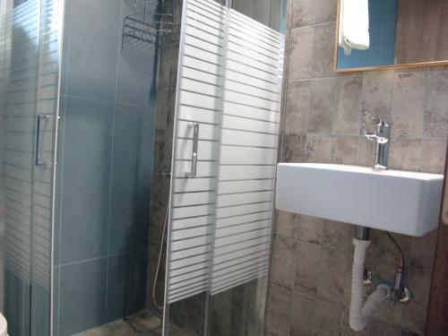 ein Bad mit einem Waschbecken und einer Dusche in der Unterkunft Pritania 2 in Komotiní