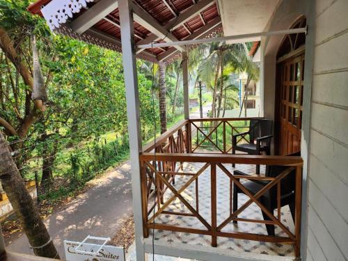 an entrance to a house with a wooden porch at Coastal Suites Apart Hotel ---- 8 minutes walk to beach in Benaulim
