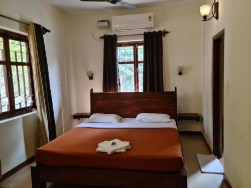 a bedroom with a large bed in a room at Coastal Suites Apart Hotel ---- 8 minutes walk to beach in Benaulim