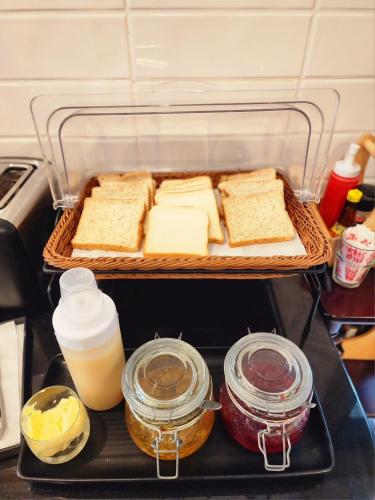 a tray with bread and other food items in a refrigerator at Nakara Hotel, Ubon Ratchathani in Ban Na Kham