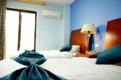 Postel nebo postele na pokoji v ubytování Conord Hotel