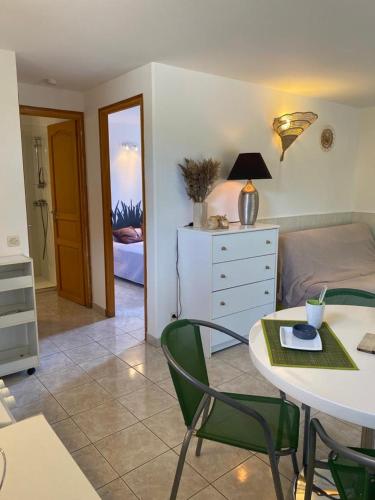 une chambre avec un lit et une table avec des chaises dans l'établissement Appartement T2 Olmeto, à Olmeto