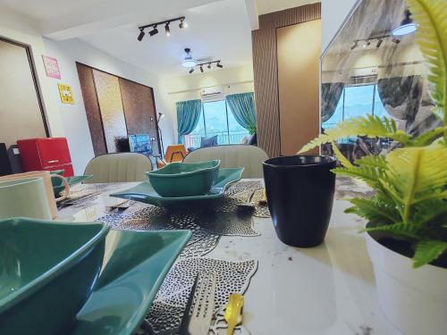 a table with green plates and plants on it at INS Pavillion by irainbow in Ipoh