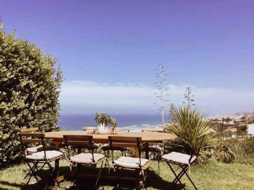 a table and chairs with a view of the ocean at Casa da Praia - Beachfront Private Pool in Colares