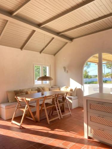 a living room with a table and a couch at Casa da Pergola - Beach Design Villa Private Pool in Santo André