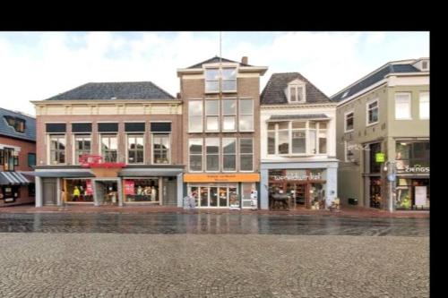 a group of buildings on a city street at Appartement met prachtig uitzicht over de binnenstad van Leeuwarden in Leeuwarden