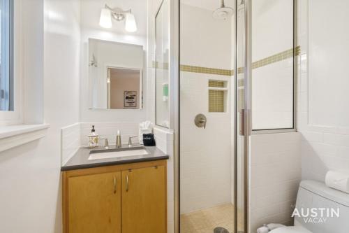 a bathroom with a sink and a shower at Essence of Austin Fully Equipped and Stylish Abode in Austin