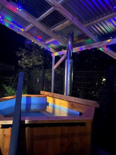 a pergola with a fountain and lights on it at Cabaña frente al mar en Carretera Austral in Puerto Montt