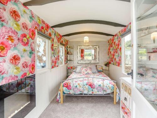 a bedroom with a bed and floral wallpaper at 1 Bed in Eden Valley 82493 in Kirkoswald