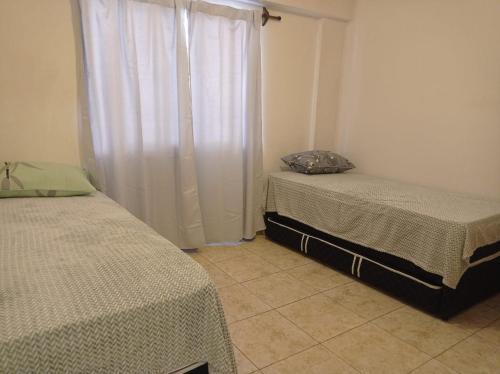 Ένα ή περισσότερα κρεβάτια σε δωμάτιο στο Departamento Viñas de Cuyo