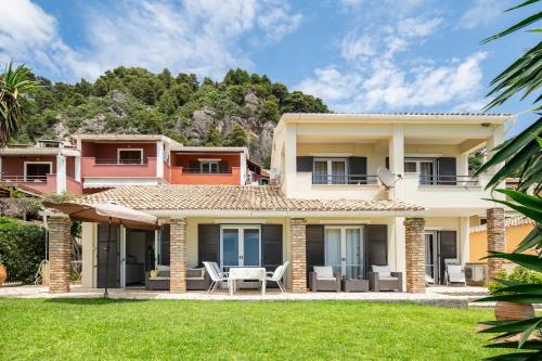 a house with a lawn in front of it at Agapi mou in Glyfada