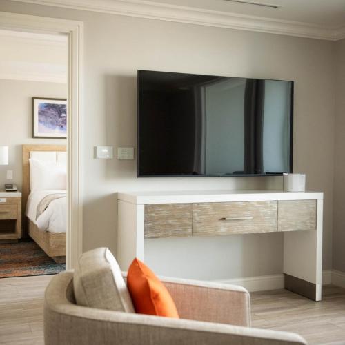 a living room with a tv and a couch at Sunseeker Resort Florida Gulf Coast, Curio Collection Hilton in Port Charlotte