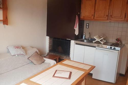 a small kitchen with a couch and a table at Chalet vue montagne T2 duplex, 6 personnes in Luz-Saint-Sauveur