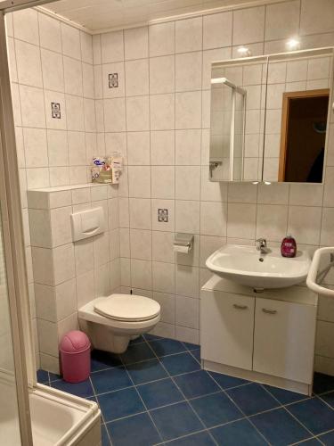 a bathroom with a toilet and a sink at Nordsee 406 in Wangerooge