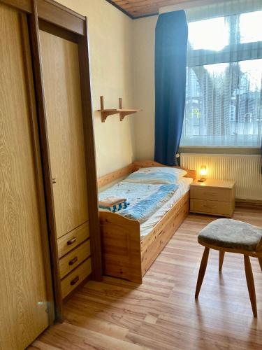 a small bedroom with a bed and a window at Nordsee 406 in Wangerooge