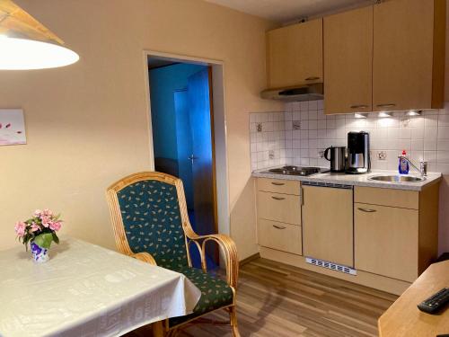 a small kitchen with a table and a table and chairs at Nordsee 08 in Wangerooge