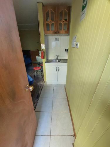 an open door to a kitchen with a sink at Noface 3 in Los Vilos