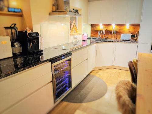 a kitchen with white cabinets and an open oven at DMG - 'The Luxury Penthouse' in Fulpmes