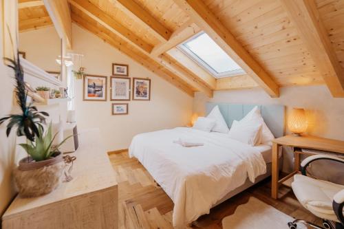 a bedroom with a bed and a skylight at DMG - 'The Luxury Penthouse' in Fulpmes